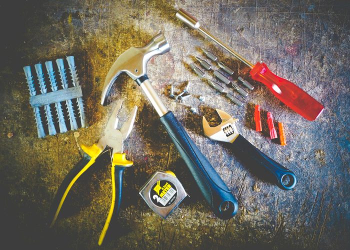 pexels-photo-175039-175039 Collection of hand tools including hammer, screwdriver, and pliers in a workshop setting.